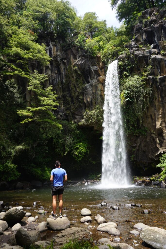 man standing in front of a waterfall in Chile